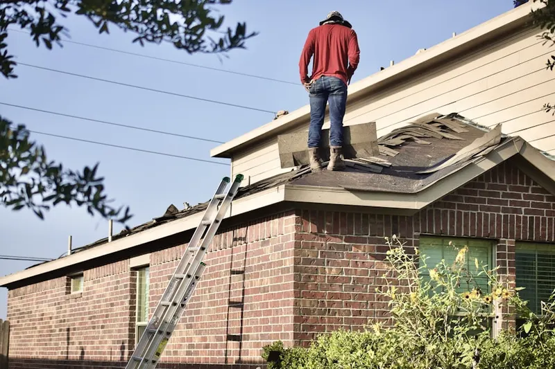 Professional roofer working on a residential roof in Tall Pines at River Ridge